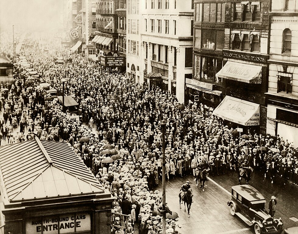 Thousands of people follow the hearses containing the remains of Sacco and Vanzetti on their way to the crematorium in Boston. 1927