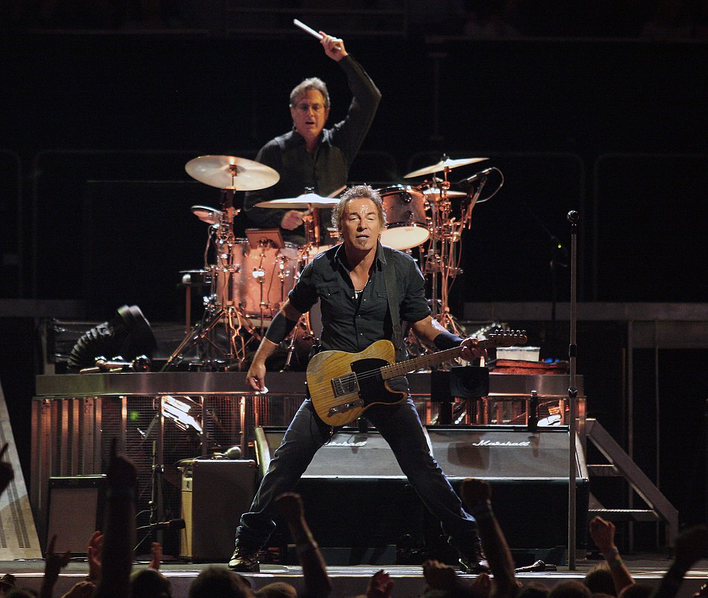 Bruce Springsteen (with Max Weinberg in background on drums) in concert, 15 August 2008. Craig ONeal