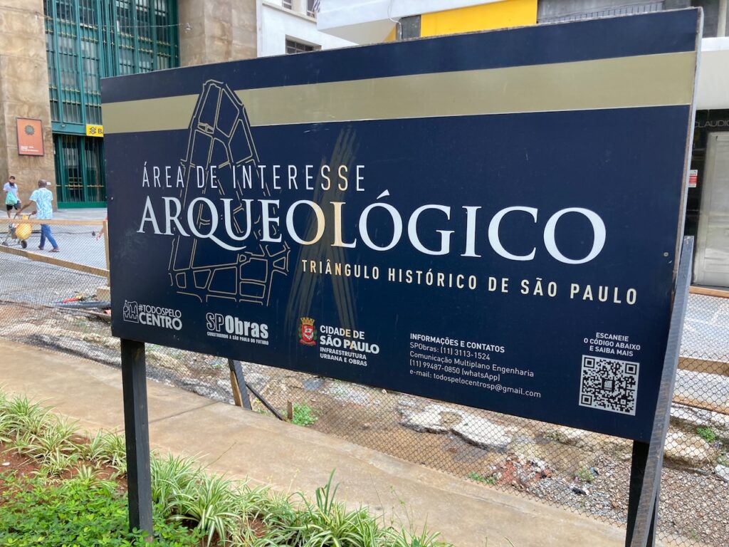 A view of a sign noting that this site is being excavated as an archaeological site in the Centro neighborhood in São Paulo