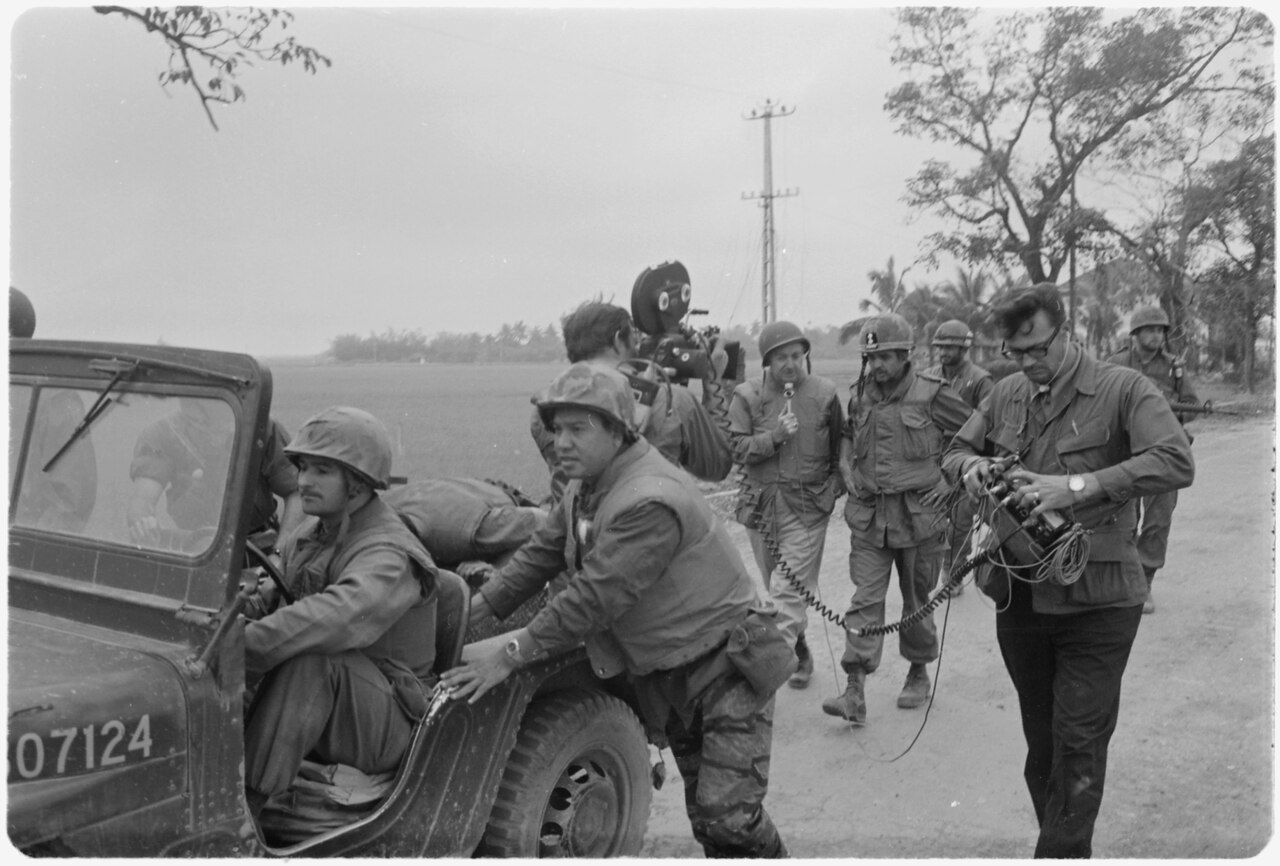 Landscape Vietnam. Walter Cronkite and a CBS Camera crew use a jeep for a dolly during an interview with the commanding officer of the 1st Battalion, 1st Marines, during the Battle of Hue City. 20 February 1968