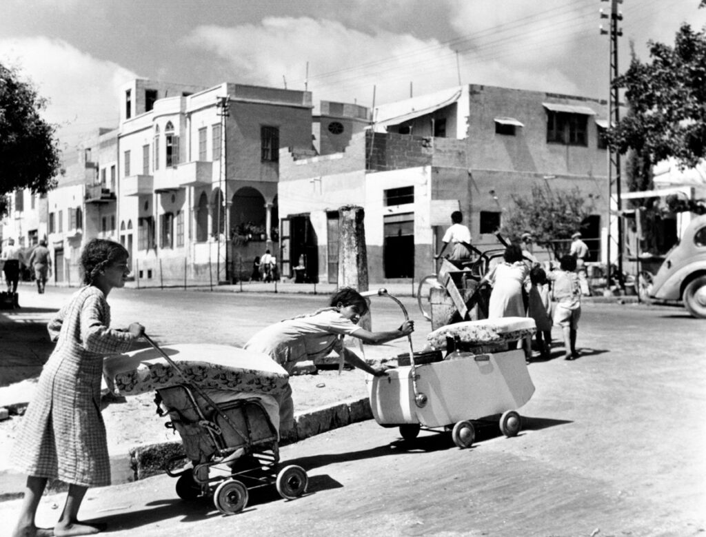 Last days in Jaffa, 1948. Barefoot and pushing their belongings in prams and carts, Arab families leave the Mediterranean costal town of Jaffa. Credit: UN Photo