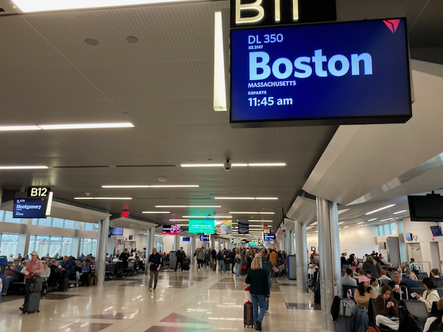 A view of a boarding gate area at Hartsfield–Jackson Atlanta International Airport for a flight to Boston, Massachusetts.