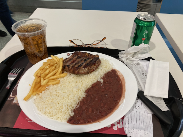 A view of a steak with beans, rice, and French fries and an Guaraná soda meal from Mania de Churrasco! Prime Steak & Burger at the food court in Shopping Center 3 Mall in São Paulo, Brasil