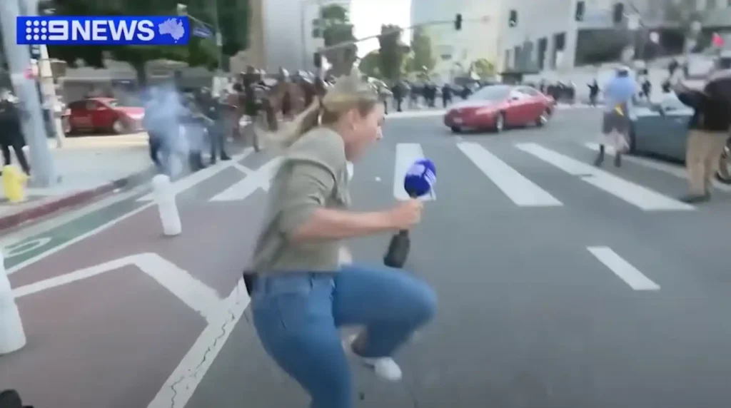 A screen grab from video footage shows Australian journalist Lauren Tomasi being shot by a police officer with a rubber bullet while reporting on protests in Los Angeles.