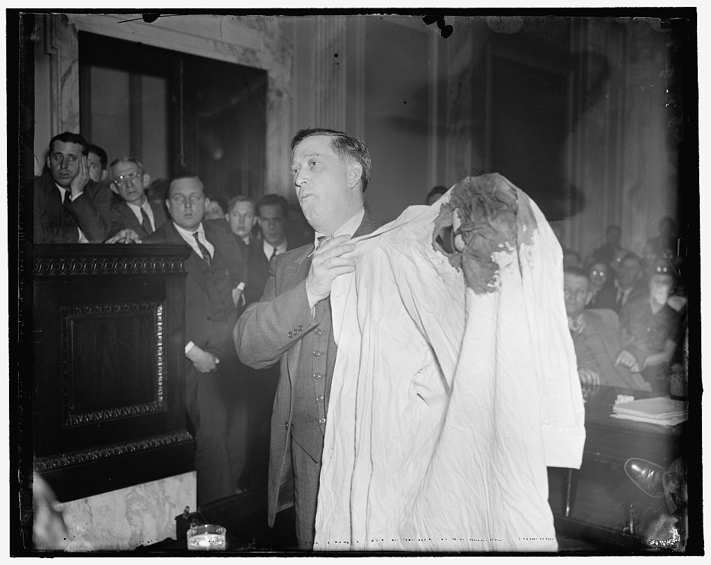 Evidence Evidence displayed to Senate Committee. Washington, D.C., April 27. A bloody bullet-torn undershirt was displayed to the Senate Civil Liberties Committee today by Thomas Ferguson, coal miner union Representative, to suport his story of having been shot last January by Harland County deputy sheriffs. He admitted that he could not identify the group of deputies who fired the shots, one of which was soft-nosed bullet that entered his shoulder and came out in the back. The Committee is investigating labor practices in "Bloody" Harlan County, Ky., coal regions, 4/27/1937. 1937 April 27. Photographed by Harris & Ewing. https://www.loc.gov/pictures/item/2016871622 Via the United States Library of Congress.