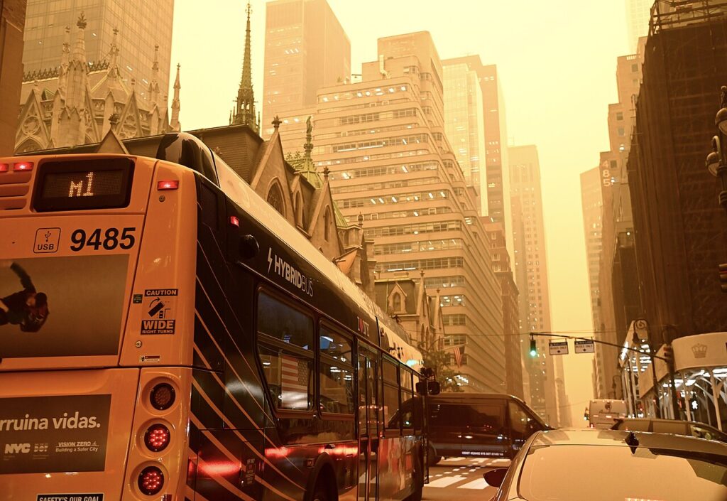 Smoke from wildfires in Quebec, Canada shrouds New York City on Wednesday, Jun 7, 2023. M1 Buses on Madison Av. near St. Patrick’s Cathedral. Marc By A. Hermann / Metropolitan Transportation Authority. Via Wikimedia Commons.